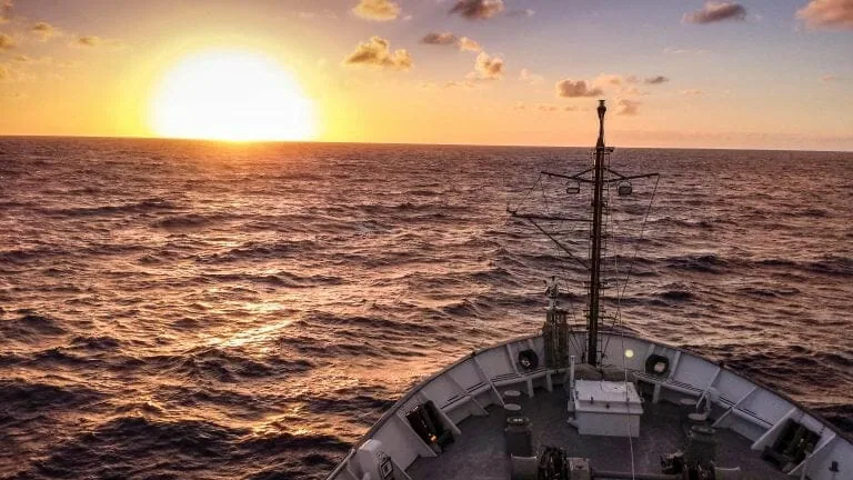 The bow of a ship at sunset, symbolizing advances in cannabis lighting technology.