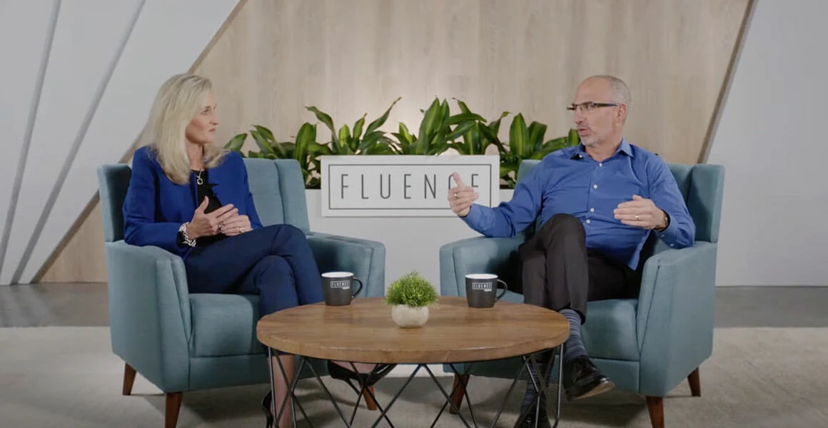 Two people discuss cannabis LED grow lights and cultivation in a modern studio.
