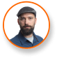 Jason Matlock, Ph.D., expert in cannabis lighting technology, wears flat cap.