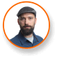 Jason Matlock, Ph.D., expert in cannabis lighting technology, wears flat cap.
