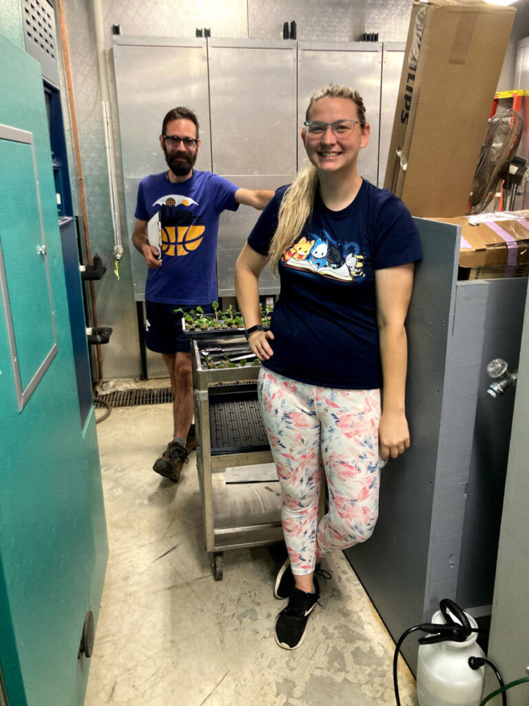 Two people in a lab with LED grow lights for cannabis and cannabis cultivation equipment.
