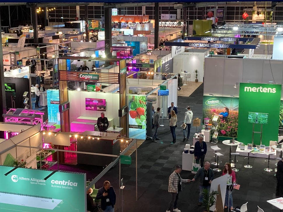 Fluence booth at trade show showcasing advanced LED lighting solutions for controlled environment agriculture; attendees explore innovative crop production technologies, with a focus on cannabis cultivation, in Austin, Texas.