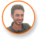 Smiling man with trimmed beard, expert in cannabis lighting technology, in frame.