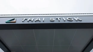 Building awning reading "THAI STICK," promoting LED grow lights for cannabis cultivation.