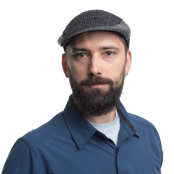 Bearded man in cap and blue shirt, expert in cannabis lighting technology.